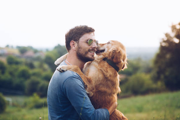 Embrace the tranquility of spring as a beautiful woman unwinds on the lush green grass of the park, accompanied by her adorable dog. Amidst the gentle breeze and blooming flowers, they savor moments of peaceful bliss, basking in the rejuvenating ambiance of the season