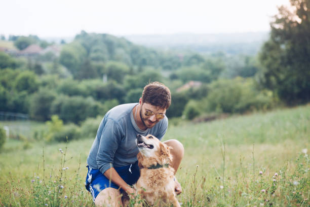 istock Guy and his dog, golden retriever, nature 1166027793