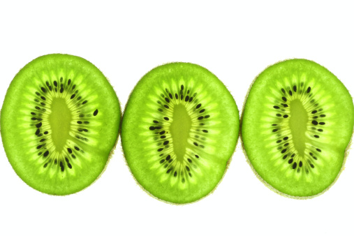 Closeup of Half kiwi fruit and segmented isolated on white background with clipping path.