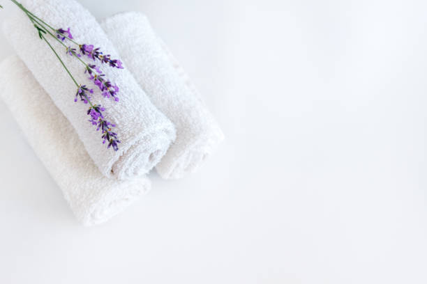istock white clean towels and lavender flowers on white isolated background 1166028543