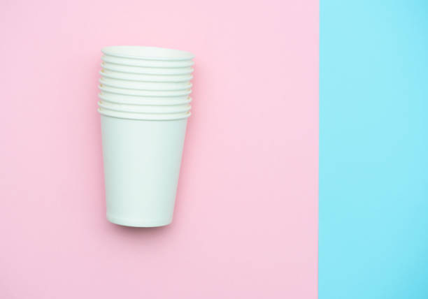istock Paper white glasses for drinks and coffee. Glasses colored background 1166029608