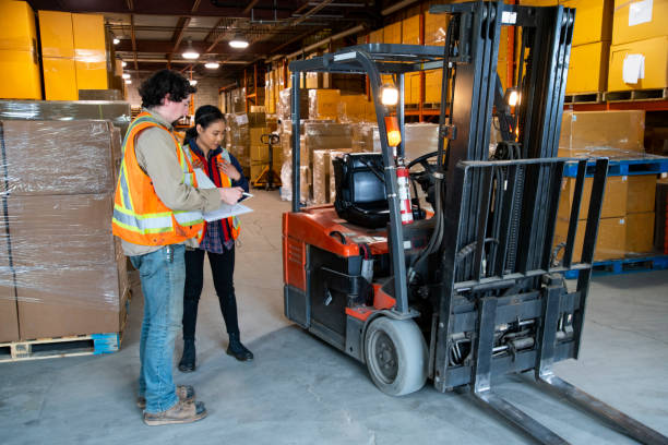 istock An industrial warehouse workplace safety topic.  A safety supervisor or manager training a new employee on forklift safety. 1166029784
