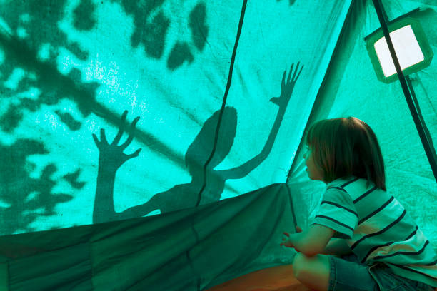 Happy hiker kids having fun in a tent. Camping fun.