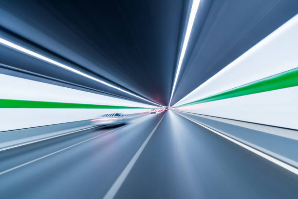 istock Blurry chromatic color tunnel car traffic motion blur. 1166034222