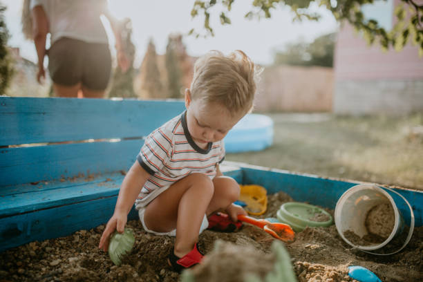 istock Child plays with his single mother in the sandbox 1166035921