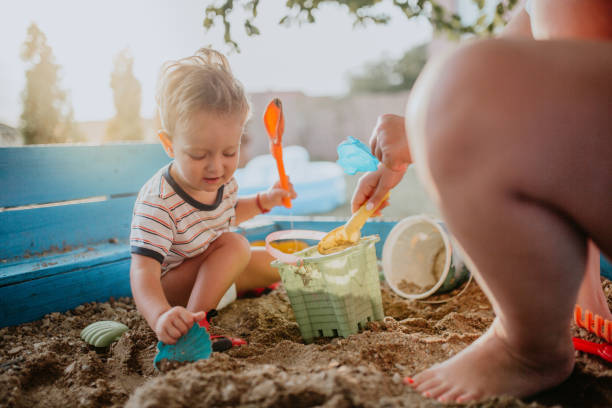 istock Child plays with his single mother in the sandbox 1166035992