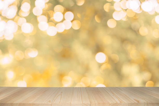 Empty wooden table on abstract background with colorful bokeh.