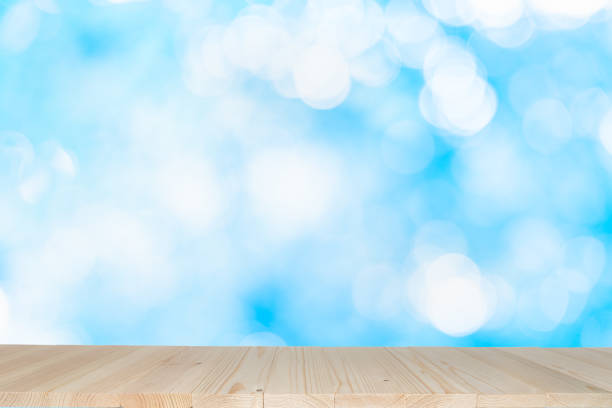 istock Empty wooden table on abstract background with colorful bokeh. 1166037013