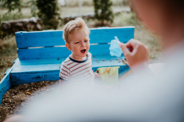 istock Child plays with his single mother in the sandbox 1166037175
