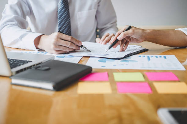 istock Co working conference, Business team colleagues discussing working analysis with financial data and marketing growth report graph in team, Meeting Talking Brainstorming Communication Concept 1166037304