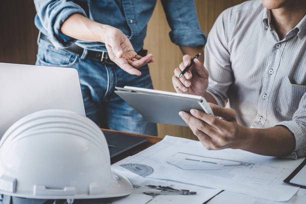 istock Engineer Teamwork Meeting, Drawing working on blueprint meeting for project working with partner on model building and engineering tools in working site, Construction and structure concept 1166037306