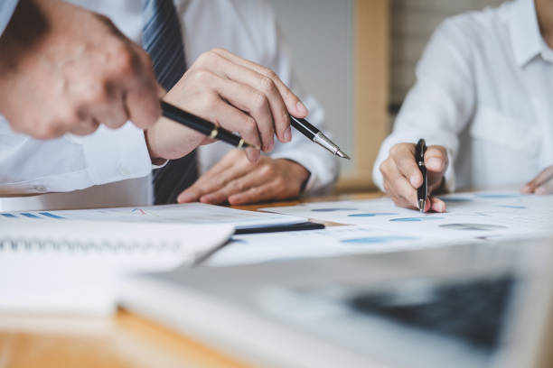 istock Co working conference, Executive team discussing the charts and graphs working in business strategy and financial plan to investment profit 1166037325