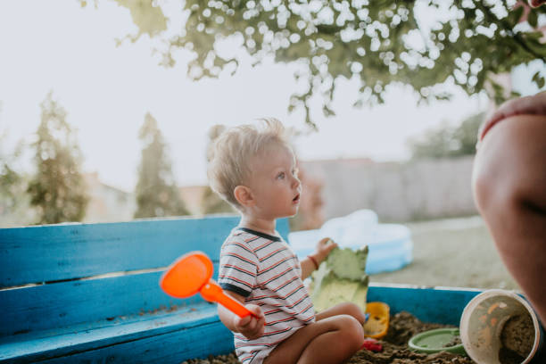 istock Child plays with his single mother in the sandbox 1166037367