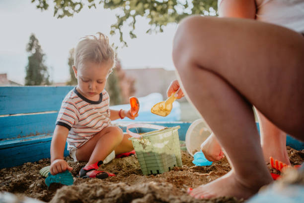 istock Child plays with his single mother in the sandbox 1166037406
