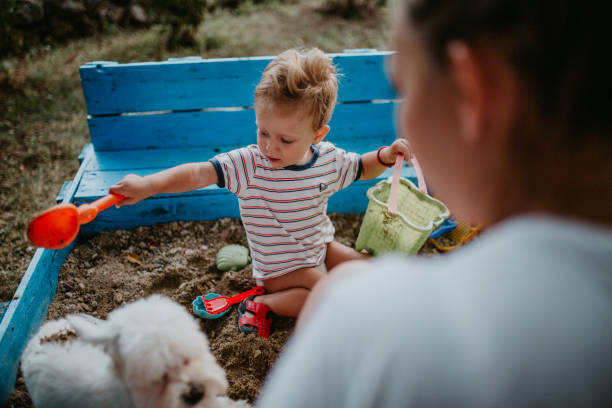 istock Child plays with his single mother in the sandbox 1166037530