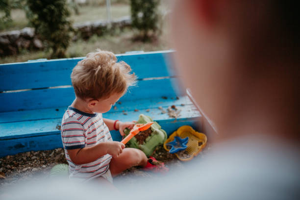 istock Child plays with his single mother in the sandbox 1166037532