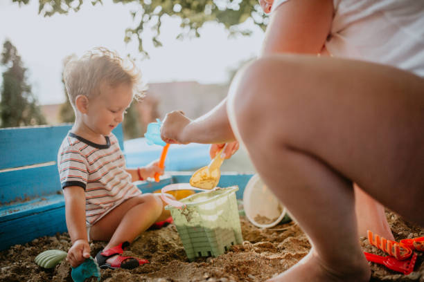 istock Child plays with his single mother in the sandbox 1166038486