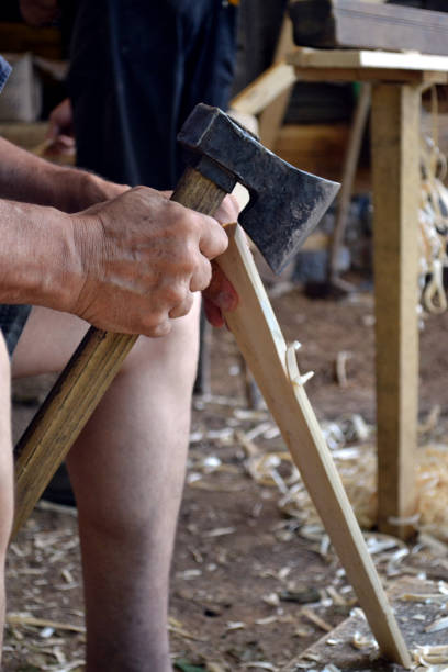 istock Wood worker carving in wood with an ax 1166039432