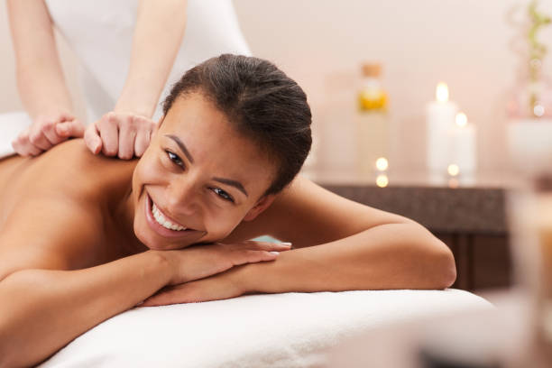 istock Smiling Woman Enjoying Massage 1166039711