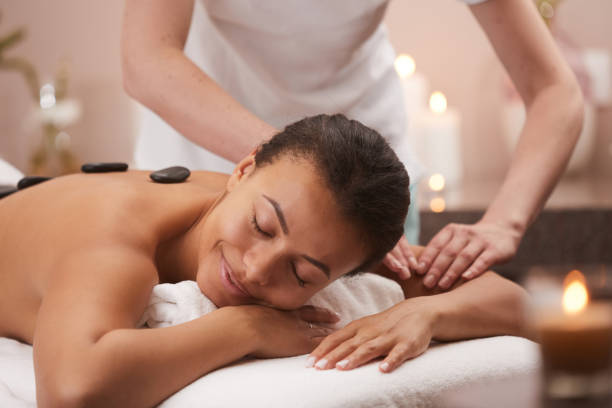 istock Woman Enjoying Stone Massage in Spa 1166039714