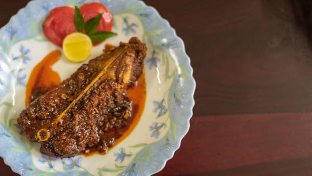 Cooked Chital Fish/ Chitol mach Top view of Cooked Chital Fish/ Chitol mach garnished with Tomato and lemon slice. Selective Focus is used. chitala stock pictures, royalty-free photos & images