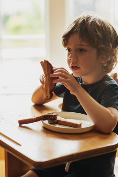 istock Boy Eating Lunch at Desk 1166040726
