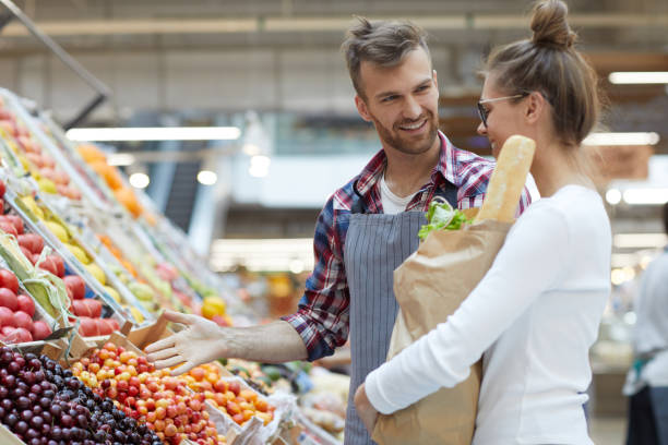 istock Male Shop Assistant Helping Customer 1166040812