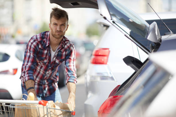 istock Man Packing Groceries into Car 1166040949