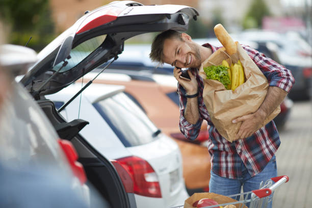 istock Smiling Young Man Packing Groceries 1166040953