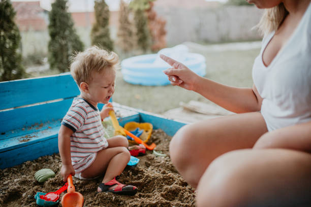 istock Child plays with his single mother in the sandbox 1166041056
