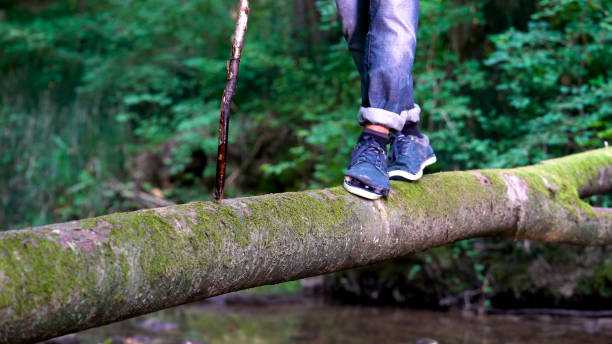 istock A Young Guy in a Torn Shoe Crossing the River. 1166042365