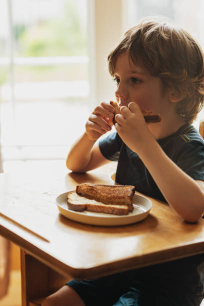 istock Boy Eating Lunch at Desk 1166042385