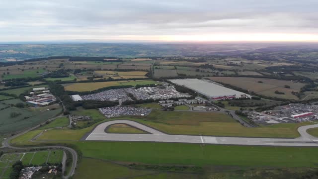 Aerial footage of the famous Leeds and Bradford airport located in the Yeadon area of West Yorkshire in the UK, typical British airport showing the runway and houses and roads around the airport