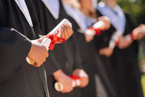 istock Graduates holding their diplomas in a roll. 1166042716