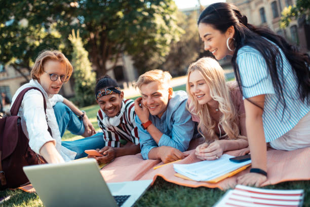 istock Students watching a movie lying on a blanket together. 1166042813