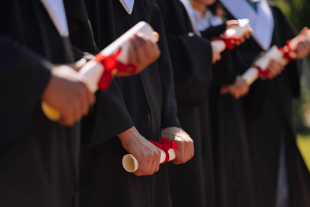 istock Young graduates holding their new masters diplomas. 1166042863