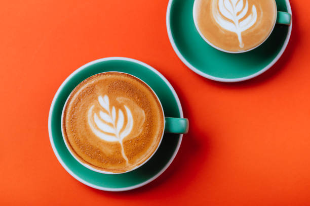 istock Cyan coffee cups over orange background. 1166044276