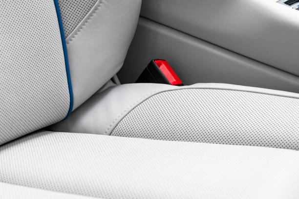 istock White leather interior of a car. Perforated white leather comfortable seats with stitching isolated on black background. Car interior details. Car detailing. Car inside 1166044348