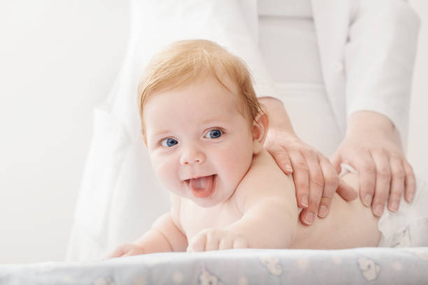 istock nurse does massage to baby 1166046409
