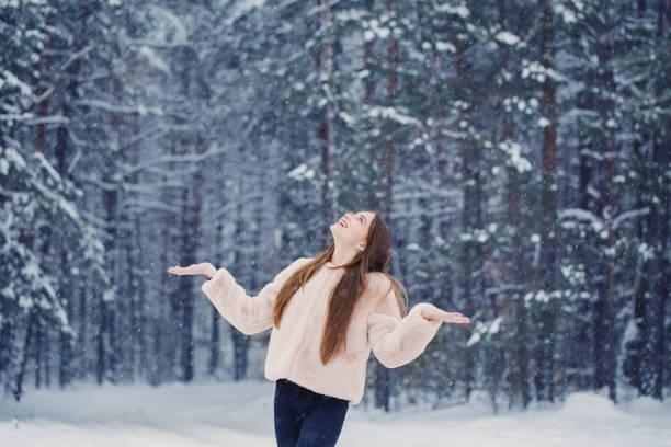 istock beautiful girl in winter forest 1166047477