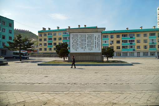 Kaesong, North Korea - May 5, 2019: Typical view of the modern Kaesong city. Apartment buildings and square with local people rushing for their business