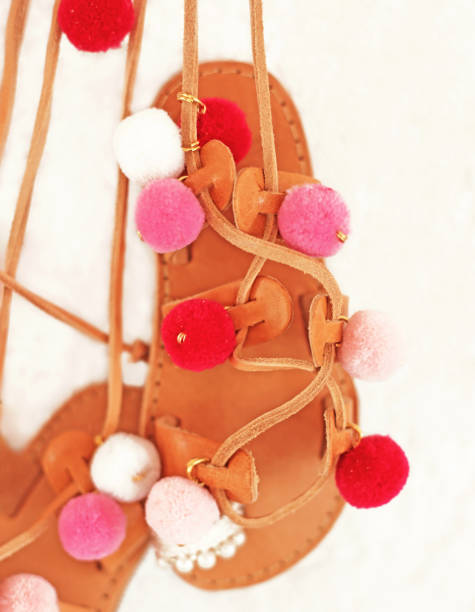 greek leather sandals for girls with colorful pom pom - gladiator sandals - kids shoes advertisement greek leather sandals for girls with colorful pom pom - gladiator sandals gladiator shoe stock pictures, royalty-free photos & images