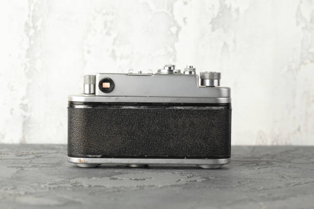 istock The old rangefinder film camera with on grey cement background. 1166048476