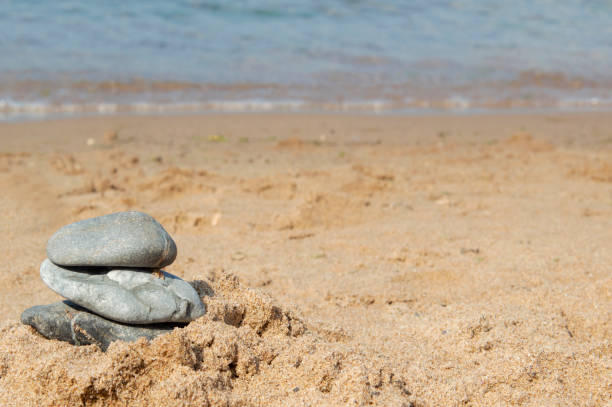 istock Relaxing in the beach, with white sand and stack of stones 1166049467