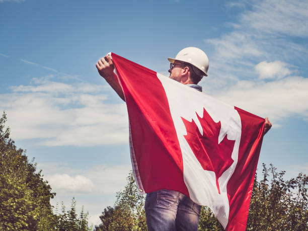 istock Engineer, holding Canadian Flag in the park 1166051093