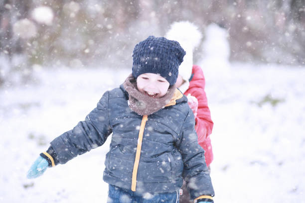 istock Kids walk in the park first snow 1166054873