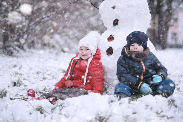 istock Kids walk in the park first snow 1166055945