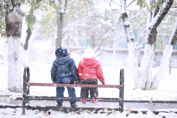 istock Kids walk in the park first snow 1166055978