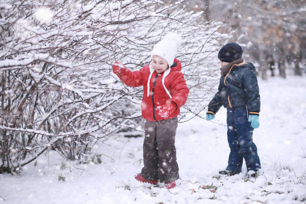 istock Kids walk in the park first snow 1166056132