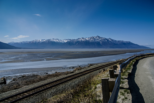 The Mud Flats of the Turnagain Arm Before the Return of the Bore Tide.  From the Seward Highway (1) Near Anchorage, Alaska.  A Beautiful Wilderness Landscape of Rock, Snow, Water and Ice.